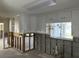 Spacious kitchen area with modern white cabinetry, tile floors, window, and exposed wall framing at 15816 2Nd St E, Redington Beach, FL 33708