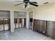 Living room with tile floors, ceiling fan and studs ready for renovation at 15816 2Nd St E, Redington Beach, FL 33708