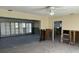 The open-concept living room has plantation shutters, concrete floors, and exposed wall framing at 15816 2Nd St E, Redington Beach, FL 33708