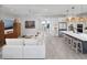 Spacious living room with a large sofa, modern furniture, and kitchen view at 17390 Moonflower Dr # 203, Venice, FL 34293