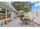 Peaceful backyard patio with a table, chairs, and a bench at 1816 Woodridge Dr, Clearwater, FL 33756