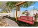 Landscaped backyard featuring a red swing and cornhole at 1816 Woodridge Dr, Clearwater, FL 33756