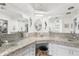 Double vanity bathroom with granite countertops and glass sinks at 1816 Woodridge Dr, Clearwater, FL 33756
