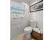 Small bathroom with toilet, sink, and shower at 1816 Woodridge Dr, Clearwater, FL 33756