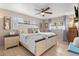 Spacious bedroom with a king-size bed and ceiling fan at 1816 Woodridge Dr, Clearwater, FL 33756