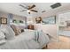 Main bedroom with king bed, ensuite bath, and TV at 1816 Woodridge Dr, Clearwater, FL 33756