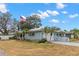 Light blue home with a two-car garage and manicured lawn at 1816 Woodridge Dr, Clearwater, FL 33756
