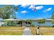 Charming light blue home with a well-maintained lawn and walkway at 1816 Woodridge Dr, Clearwater, FL 33756