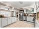 Bright kitchen with stainless steel appliances and white cabinets at 1816 Woodridge Dr, Clearwater, FL 33756