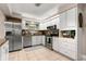 Updated kitchen, featuring white cabinets and stainless steel appliances at 1816 Woodridge Dr, Clearwater, FL 33756