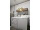 Functional laundry room with washer, dryer, and shelving at 1816 Woodridge Dr, Clearwater, FL 33756