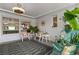 Bright screened porch with seating, plants and fan at 1816 Woodridge Dr, Clearwater, FL 33756
