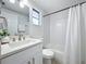 Clean bathroom with white vanity, a bathtub, and updated fixtures at 2460 Terry Ln, Sarasota, FL 34231