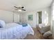 Bright bedroom with ceiling fan, and access to a private bathroom at 2460 Terry Ln, Sarasota, FL 34231