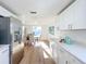 Open kitchen with stainless steel appliances and view to dining area at 2460 Terry Ln, Sarasota, FL 34231