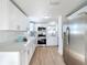 Bright kitchen featuring white shaker cabinets and stainless steel appliances at 2460 Terry Ln, Sarasota, FL 34231
