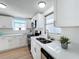 Modern kitchen with white cabinets, stainless steel appliances, and a double sink at 2460 Terry Ln, Sarasota, FL 34231
