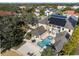 A beautiful aerial view of this home reveals a backyard pool, patio and solar panels at 3025 Oakmont Dr, Clearwater, FL 33761