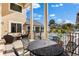 Back porch with ornate chairs and table that overlooks a swimming pool with a fountain in the distance at 3025 Oakmont Dr, Clearwater, FL 33761