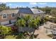 Stunning two-story home featuring manicured landscaping, a metal roof, and a circular driveway at 3025 Oakmont Dr, Clearwater, FL 33761