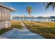 Backyard with a concrete path leading to the water at 325 173Rd E Ave, North Redington Beach, FL 33708