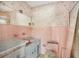 Pink tiled bathroom with vintage vanity and toilet at 3700 Dana Shores Dr, Tampa, FL 33634