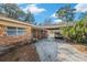 Carport with brick exterior and a car parked inside at 3700 Dana Shores Dr, Tampa, FL 33634
