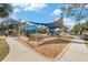 Community playground with shade structures and play equipment at 3700 Dana Shores Dr, Tampa, FL 33634