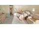 Another view of the bedroom featuring neutral decor, a bed, and access to a private bathroom at 7000 Beach Plz # 706, St Pete Beach, FL 33706