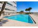 Inviting community pool with ample lounge chairs and a view of the beach at 7000 Beach Plz # 706, St Pete Beach, FL 33706