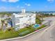 Aerial view showcasing pool, shuffleboard court, and beach proximity at 7000 Beach Plz # 706, St Pete Beach, FL 33706