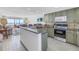 Open kitchen with granite counters, modern appliances, and ocean views at 7000 Beach Plz # 706, St Pete Beach, FL 33706
