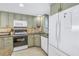 Another view of the kitchen, emphasizing the arrangement of appliances and cabinets, with ample counter space at 7000 Beach Plz # 706, St Pete Beach, FL 33706