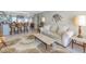 Coastal living room with white sofa, breakfast bar, and unique decor at 7000 Beach Plz # 706, St Pete Beach, FL 33706
