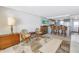 Living area with wicker furniture, breakfast bar, and coastal decor at 7000 Beach Plz # 706, St Pete Beach, FL 33706