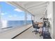 Bright sunroom with panoramic ocean views, perfect for a home office or relaxation space at 7000 Beach Plz # 706, St Pete Beach, FL 33706