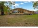 Backyard view of a single-story home with a wooden deck at 703 W Sligh Ave, Tampa, FL 33604