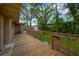 Large wooden deck and grassy backyard with trees and a shed at 703 W Sligh Ave, Tampa, FL 33604