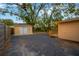 Paved area, storage shed, and wooden steps to a deck in the backyard at 703 W Sligh Ave, Tampa, FL 33604