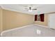 Empty bedroom with tile flooring, ceiling fan, and window with curtains at 703 W Sligh Ave, Tampa, FL 33604