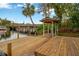 Large wooden dock on the water with a covered sitting area and a nearby bridge at 703 W Sligh Ave, Tampa, FL 33604