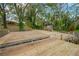 Expansive wooden dock perfect for boats, with a view of the house and surrounding trees at 703 W Sligh Ave, Tampa, FL 33604