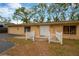 Front view of a single-story home with a white picket fence at 703 W Sligh Ave, Tampa, FL 33604
