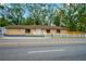 Single-story home with white picket fence and paved driveway at 703 W Sligh Ave, Tampa, FL 33604