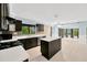 Modern kitchen with dark cabinets, an island, and stainless steel appliances at 703 W Sligh Ave, Tampa, FL 33604