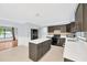 Stylish kitchen with a large island, dark cabinets, and stainless steel appliances at 703 W Sligh Ave, Tampa, FL 33604