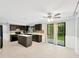 Modern kitchen with dark wood cabinets, white countertops, and stainless steel appliances at 703 W Sligh Ave, Tampa, FL 33604