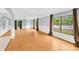 Living room with wood-look floors, large windows, and a chandelier at 703 W Sligh Ave, Tampa, FL 33604