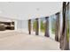 Sunroom or bonus room with tile flooring and view to the kitchen at 703 W Sligh Ave, Tampa, FL 33604