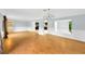 Open living room with wood-look floors and view into the kitchen at 703 W Sligh Ave, Tampa, FL 33604